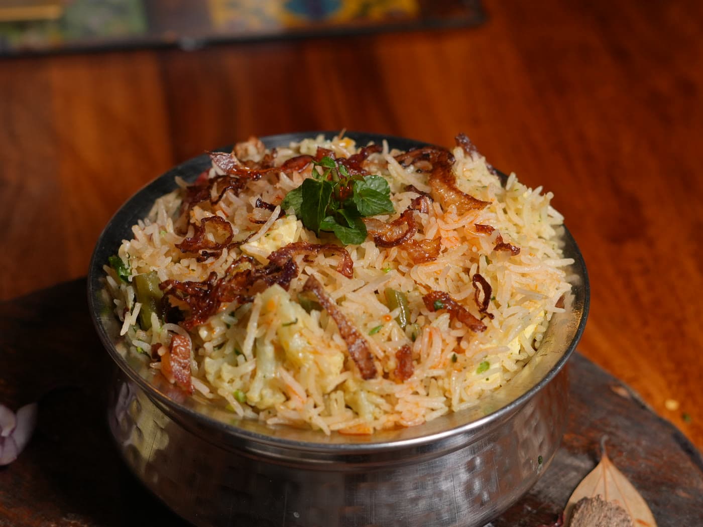 Dum biryani finished with fried onion and mint